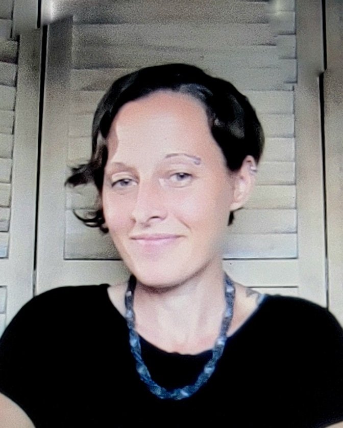 Katie, somatic coach, smiling warmly
